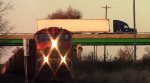 Semi passes over BNSF train